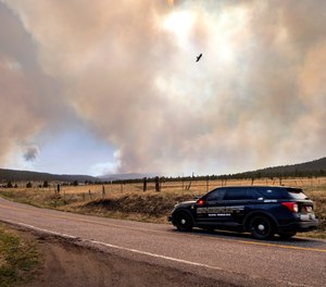 San Miguel County Sheriff's Officers patrol N.M. 94 near Penasco Blanco, N.M., as the Calf Fire burns nearby. Destructive Southwest fires have burned dozens of homes in northern Arizona and put numerous small villages in New Mexico in the path of danger, as wind-fueled flames chewed up wide swaths of tinder dry forest and grassland and towering plumes of smoke filled the sky.