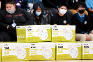 Boxes of KN95 masks are stacked up before being distributed to students at Camden High School in Camden, N.J., on Feb. 9, 2022. According to a study by the Centers for Disease Control and Prevention released Tuesday, three out of every four U.S. children have been infected with COVID-19.