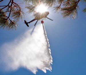 In this file photo provided by the New Mexico National Guard, New Mexico National Guard Aviation soldiers execute water drops as part of efforts to stop the Calf Canyon/Hermits Peak Fire in northern New Mexico on May 1.
