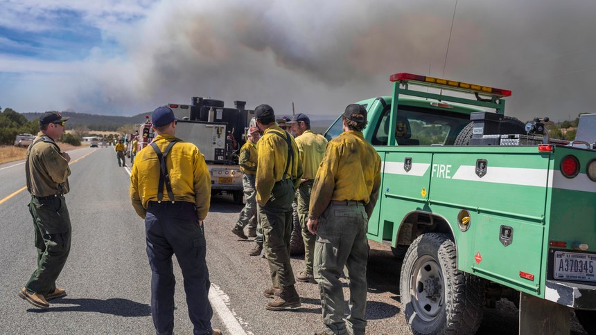 Wildland firefighters from several agencies throughout the country wait along state road 283 to be sent into the Hermits Peak and Calf Canyon Fires burning just west of Las Vegas, N.M.