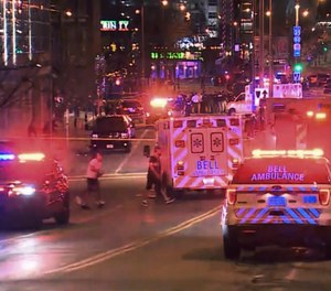 This photo taken from video provided by WISN 12 News shows police responding to the scene of a shooting at Water Street and Juneau Avenue in Milwaukee, Friday, May 13, 2022.