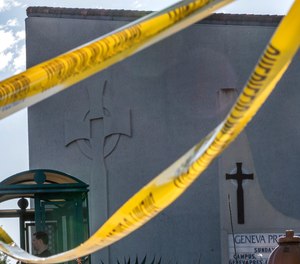 Crime scene tape is stretched across the exterior of the Geneva Presbyterian Church in Laguna Woods, Calif., Sunday, May 15, 2022, after a fatal shooting.