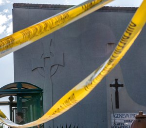 Crime scene tape is stretched across the exterior of the Geneva Presbyterian Church in Laguna Woods, Calif., Sunday, May 15, 2022, after a fatal shooting.