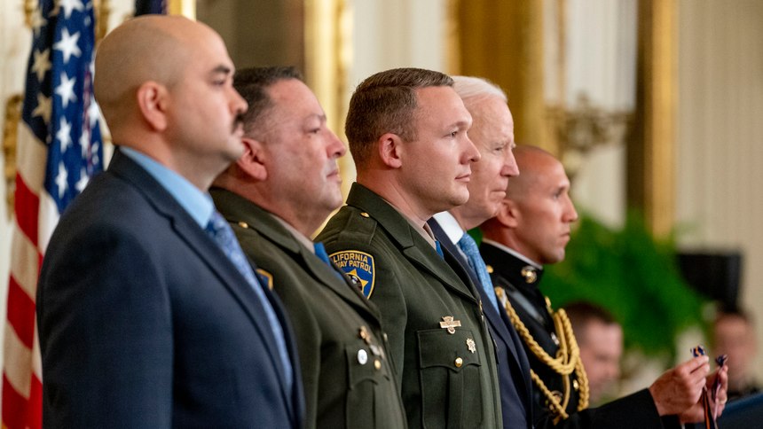 From left, California Highway Patrol officers Robert Paul III, Vincent Mendoza, and Ryan Smith, stand with President Joe Biden before they are awarded the Public Safety Officer Medal of Valor in the East Room of the White House, Monday, May 16, 2022 in Washington, D.C.