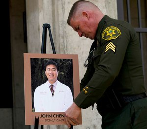 Orange County Sheriff's Sgt. Scott Steinle displays a photo of Dr. John Cheng, a 52-year-old victim who was killed in Sunday's shooting at Geneva Presbyterian Church, during a news conference in Santa Ana, Calif., Monday, May 16, 2022.