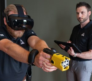 A man demonstrates Axon's VR equipment and a version of the TASER 7 that utilizes VR technology for training on Thursday, May 12, 2022, in Washington.