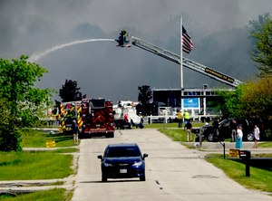 Emergency crews work to extinguish a fire at Summerset Marine Construction in Eagle, Wis., on Thursday. Six people were hurt, including three firefighters, when an explosion and fire rocked the marine construction company in southeast Wisconsin on Thursday.