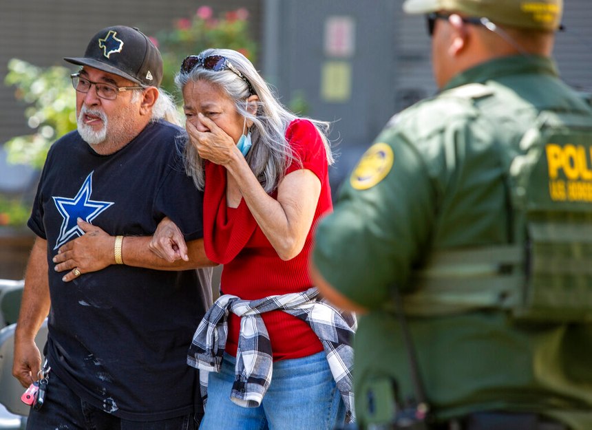 A woman cries as she leaves the Uvalde Civic Center on Tuesday in Uvalde, Texas, where an 18-year-old gunman opened fire at Robb Elementary School.