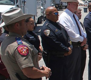 Uvalde School Police Chief Pete Arredondo, third from left, stands during a news conference outside of the Robb Elementary school in Uvalde, Texas Thursday, May 26, 2022.