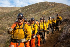 In this undated image provided by the Forestry and Fire Recruitment Program, firefighters from the Forestry and Fire Recruitment Program pause in the Angeles National Forest near Los Angeles. The Forestry and Fire Recruitment Program has trained more than 3,000 people and helped more than 140 get jobs.