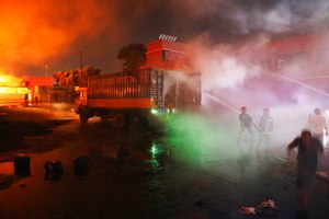 Firefighters work to contain a fire that broke out at the BM Inland Container Depot, a Dutch-Bangladesh joint venture, in Chittagong early Sunday.