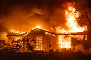 In this Sept. 27, 2020, file photo, a house burns on Platina Road during the Zogg Fire near Ono, Calif. Pacific Gas & Electric on Thursday pleaded not guilty to involuntary manslaughter and other charges it faces after its equipment sparked a Northern California wildfire in 2020 that killed four people and destroyed hundreds of homes.