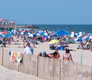 Beachgoers enjoy a sunny day on the beach in Point Pleasant Beach, N.J., on July 15, 2019. Point Pleasant Beach's mayor said on June 10, 2022, that it would join Long Branch, N.J., in seeking court orders to prevent so-called 