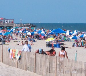 Beachgoers enjoy a sunny day on the beach in Point Pleasant Beach, N.J., on July 15, 2019. Point Pleasant Beach's mayor said on June 10, 2022, that it would join Long Branch, N.J., in seeking court orders to prevent so-called