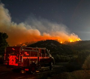 A fire engine is seen as the Sheep fire burns in Wrightwood, Calif., Monday, June 13, 2022.