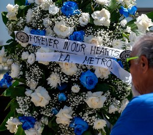 A wreath is displayed at a memorial outside El Monte City Hall Wednesday, June 15, 2022, after two police officers were shot and killed Tuesday, at a motel in El Monte, Calif.
