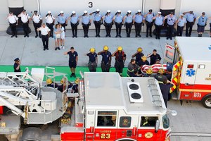 Philadelphia firefighter Lt. Sean Williamson, who was killed in an early morning building collapse, is received by his fellow firefighters and taken into the Medical Examiners office, on 15th Street near Callowhill Street, as police and others stand by, Saturday, June 18, 2022.