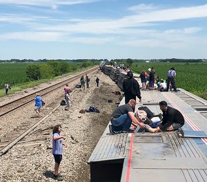 An Amtrak passenger train lies on its side after derailing near Mendon, Mo., on Monday, June 27, 2022. The Southwest Chief, traveling from Los Angeles to Chicago, was carrying about 243 passengers when it collided with a dump truck near Mendon, Amtrak spokeswoman Kimberly Woods said.