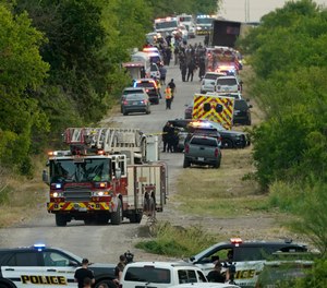 Emergency vehicles at the scene where a semitrailer with multiple dead bodies were discovered, Monday, June 27, 2022, in San Antonio.