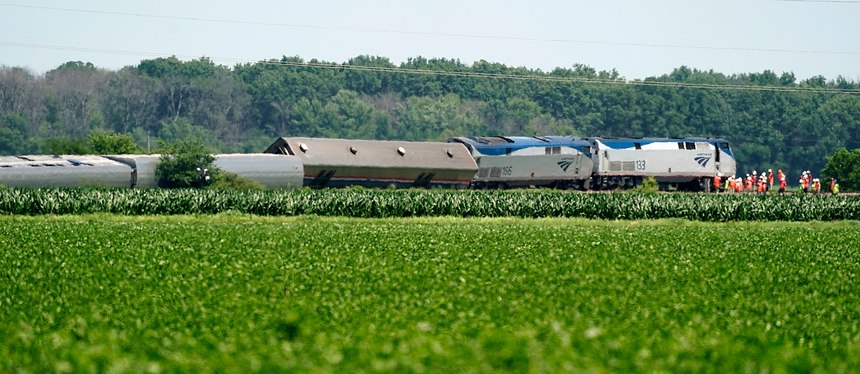 Workers gather at the front of a derailed Amtrak train Tuesday, June 28, 2022, near Mendon, Mo. The Chicago-bound train derailed Monday after striking a dump truck.