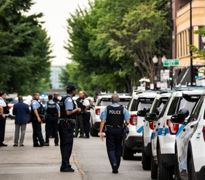 Chicago police investigate in the 1300 block of West Taylor Street after officials said an officer was shot multiple times while responding to a call of a domestic disturbance in a University Village neighborhood apartment building, Friday morning, July 1, 2022, in Chicago.