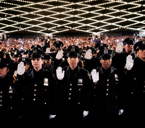 New York City Police Academy graduates raise their right hands as they take their oath during their graduation ceremony at Madison Square Garden, Friday, July 1, 2022, in New York.