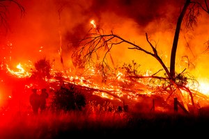 Firefighters battled the Electra Fire in the Rich Gulch community of Calaveras County, Calif., on Monday. According to Amador County Sheriff Gary Redman, about 100 people sheltered at a Pacific Gas & Electric facility before being evacuated in the evening.