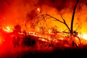 Firefighters battled the Electra Fire in the Rich Gulch community of Calaveras County, Calif., on Monday. According to Amador County Sheriff Gary Redman, about 100 people sheltered at a Pacific Gas & Electric facility before being evacuated in the evening.