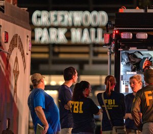 FBI agents gather at the scene of a deadly shooting, Sunday, July 17, 2022, at the Greenwood Park Mall, in Greenwood, Ind.