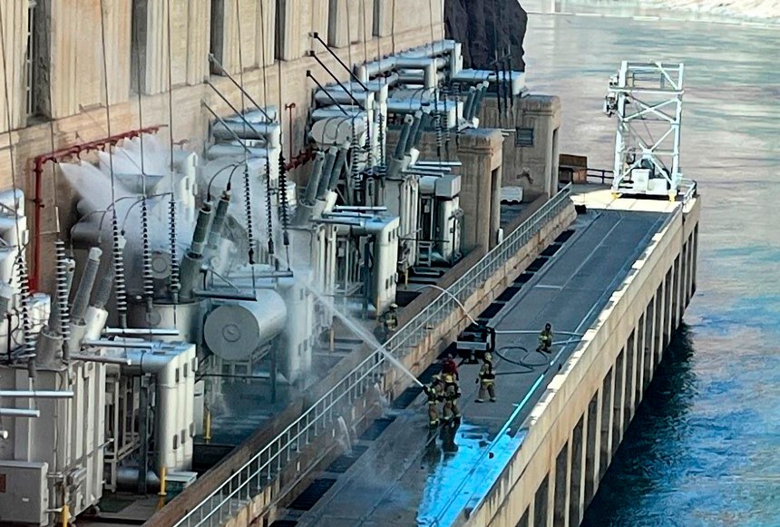 Firefighters extinguish a fire at the Hoover Dam that borders Nevada and Arizona on Tuesday, July 19, 2022, near Boulder City, Nev. 