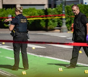 Police investigate an overnight fatal shooting in Portland, Ore., on July 17, 2021. The city's mayor on Thursday, July 21, 2022, declared a state of emergency due to spiking gun violence, with the goal to reduce fatal shootings by 10% over the next two years.