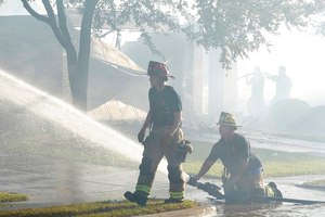 Firefighters work on putting out hot spots after several homes burned in Balch Springs, Texas, on Monday.