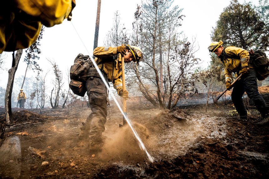 Firefighter Sergio Porras mops up hot spots while battling the Oak Fire in the Jerseydale community of Mariposa County, Calif., on Monday, July 25, 2022. He is part of Task Force Rattlesnake, a program comprised of Cal Fire and California National Guard firefighters.