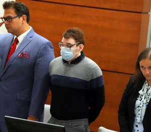Marjory Stoneman Douglas High School shooter Nikolas Cruz stands with Chief Assistant Public Defender David Wheeler and sentence mitigation specialist Kate O'Shea.