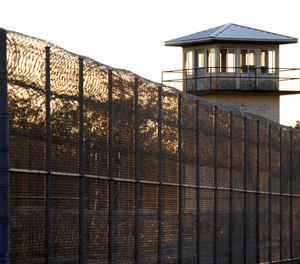 The sun sets behind Holman Prison in Atmore, Ala., on Jan. 27, 2022. Alabama’s prison commissioner did not explain what caused a lethal injection to be delayed more than two hours Thursday, July 28, 2022, beyond saying staff members were being careful, but others said the delay was troubling and raises questions about what happened. (AP Photo/Jay Reeves, File)