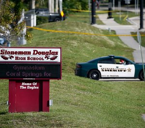 In this Feb. 15, 2018, file photo, law enforcement officers block off the entrance to Marjory Stoneman Douglas High School in Parkland, Fla., the day after the mass casualty incident.