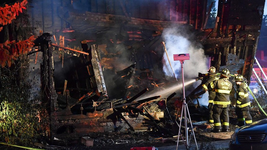 Firefighters set up lights in front of a fatal house fire at 733 First Street in Nescopeck, Pa, Friday, Aug. 5, 2022. The fire in Nescopeck was reported around 2:30 a.m. The cause of the fire remains under investigation.