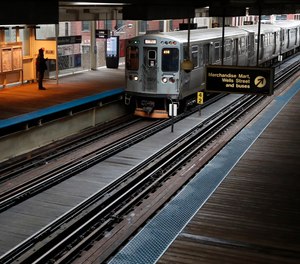 A man stands in a heating shelter at the Chicago Transit Authority's Merchandise Mart