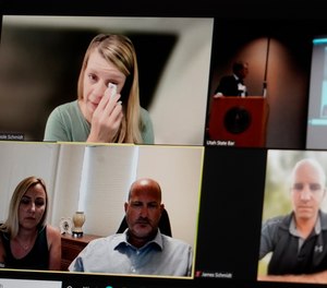 Gabby Petito's mother Nichole Schmidt, upper left, wipes a tear from her face as other family members look on during a news conference.