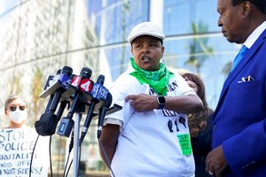 Kareim McKnight (center) talks to reporters during a press conference outside Chase Center.