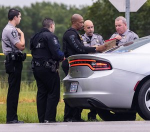 Wake County Sheriff deputies work at the scene where a deputy was shot and killed in eastern Wake County, N.C.
