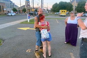 Nescopeck Volunteer Fire Company firefighter Harold Baker is comforted at the scene in Berwick, Pa., on Aug. 13, 2022.