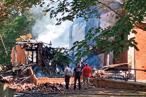 Lafayette County Fire Chief Wes Anderson (right) and county firefighters inspect the aftermath of a fire at College Hill Presbyterian Church near Oxford, Miss., Sunday morning after a Saturday night fire destroyed the majority of the historical structure. The church which was built in 1844.