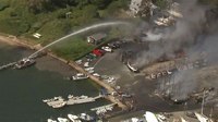 Video: Mass. boat yard blaze seriously injures man; 3 firefighters treated for heat, exertion