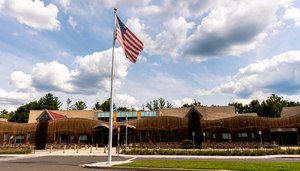 A flagpole stands outside Sandy Hook Elementary School, Tuesday, Aug. 16, 2022, in Sandy Hook, Conn. The school, which opened in 2016, replaced the one that was demolished after 20 first graders and six educators were shot and killed in December 2012. The flagpole was the only part of the old school left untouched.