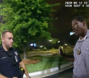This screen grab taken from body camera video provided by the Atlanta Police Department shows Rayshard Brooks, right, as he speaks with Officer Garrett Rolfe.