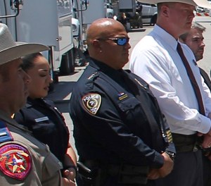 Uvalde School Police Chief Pete Arredondo, third from left, stands during a news conference outside of the Robb Elementary school on May 26, 2022, in Uvalde, Texas.