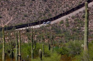 U.S. Customs and Patrol Patrol agents sat along a section of the international border wall that runs through Organ Pipe Cactus National Monument on Aug. 22, 2019 in Lukeville, Ariz. The Border Patrol says one of its agents rescued an infant and a toddler on Thursday.