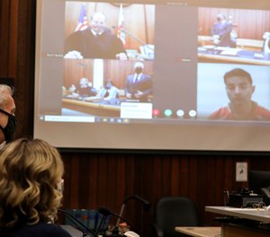 Santa Cruz County District Attorney Jeff Rosell speaks as proceedings get under way on Friday, June 12, 2020 during the arraignment of Steven Carrillo, seen in a video link at far right, for the killing of Santa Cruz Sheriff's Deputy Damon Gutzwiller in Santa Cruz, Calif.