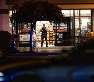 Emergency personnel respond to a shooting at the Forum shopping center in east Bend, Ore., Sunday, Aug. 28, 2022.